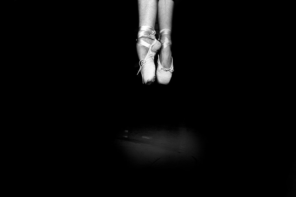 Description: Ballerina's feet in pointe shoes leaving the ground. Photographed at the Julio Bocca ballet school in Buenos Aires, Argentina. Copyright: Sebastian Rich/All rights reserved. 